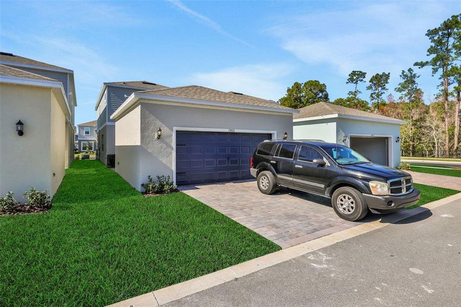Front exterior of a new home in Serenade at Ovation, Winter Garden, FL, highlighting curb appeal (Image 23).