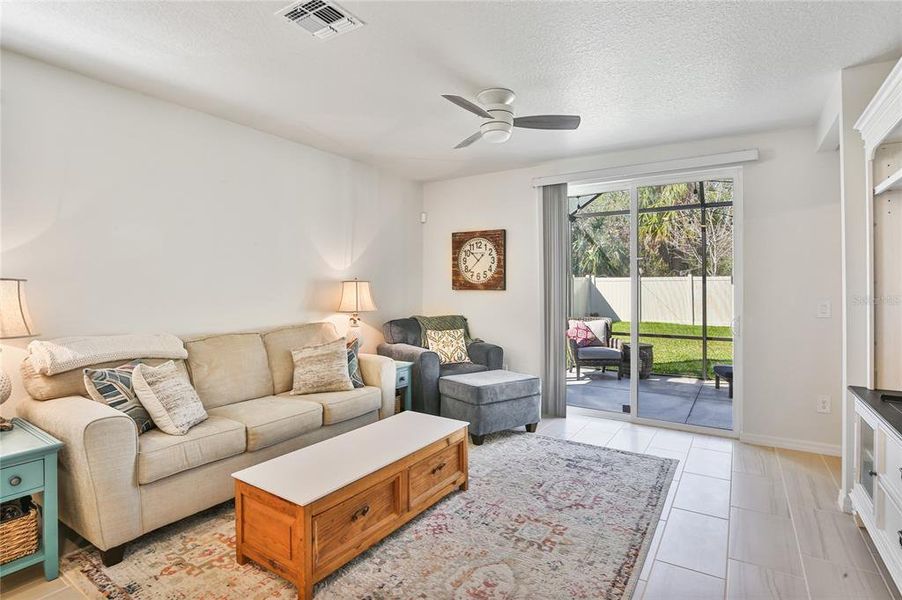 Living Area out to the Screened in Patio & Fenced Backyard