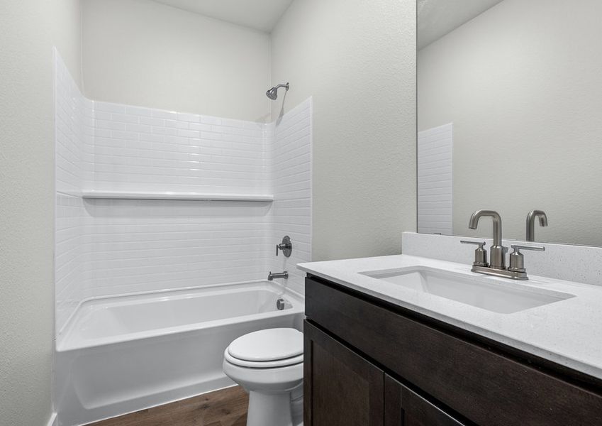 The secondary bathroom has a sprawling vanity space and a shower-tub combo. The secondary bathroom has a sprawling vanity space and a shower-tub combo.