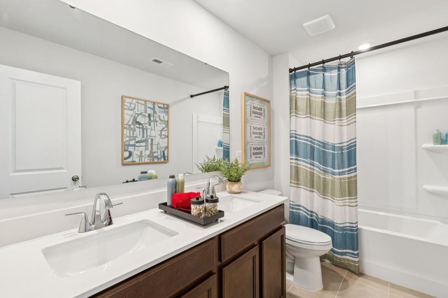 A bathroom with a tub sink and toilet. A bathroom with a tub sink and toilet.