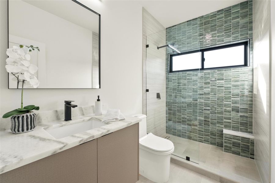 Full bath featuring toilet, a shower stall, and vanity