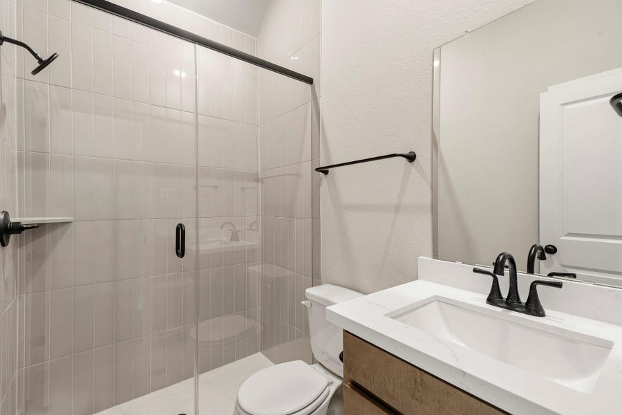 Who needs a powder room when you can have a full bathroom, complete with a mudset glass shower. Tile to the ceiling and sleek matte black hardware throughout! Who needs a powder room when you can have a full bathroom, complete with a mudset glass shower. Tile to the ceiling and sleek matte black hardware throughout!