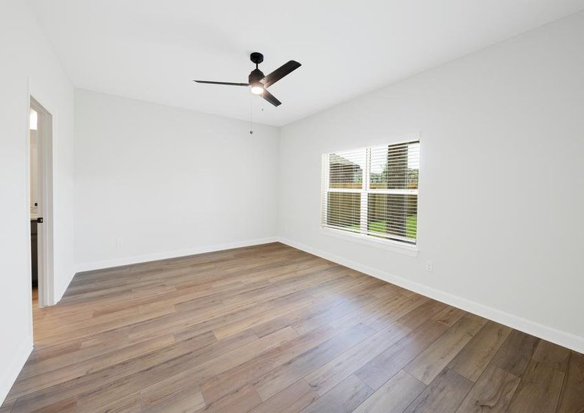 Master bedroom with ceiling fan and plank flooring