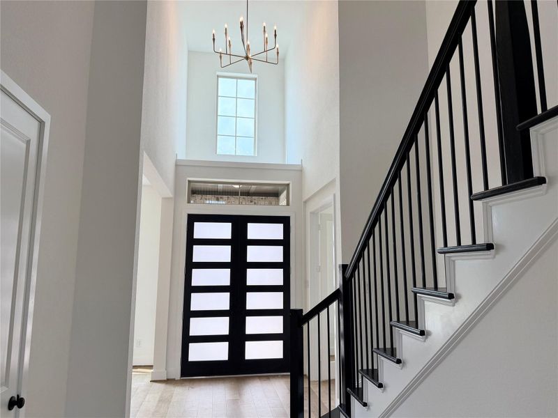 Elegant foyer - double doors and hardwood staircase
