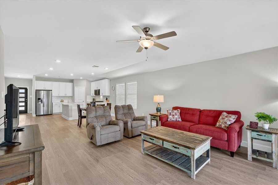 Open-concept living space featuring wood-finish flooring, recessed lighting, and a ceiling fan Open-concept living space featuring wood-finish flooring, recessed lighting, and a ceiling fan