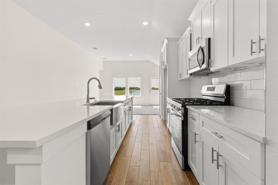 Elevated kitchen features soft closing drawers and cabinets