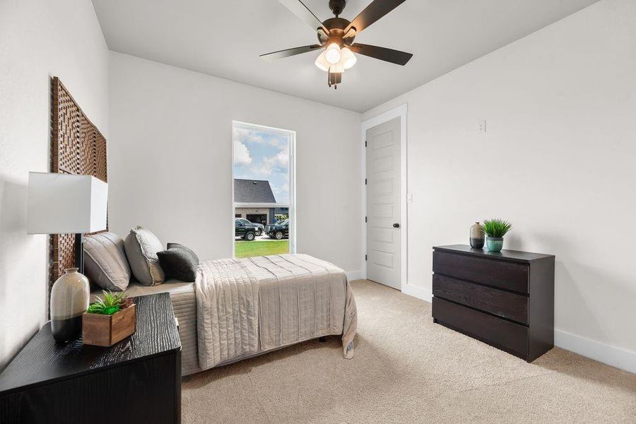 Bedroom featuring carpet flooring and a ceiling fan Bedroom featuring carpet flooring and a ceiling fan