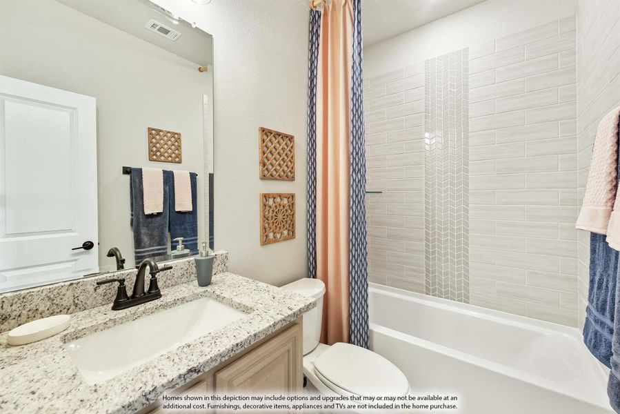 Bathroom with granite vanity, single sink, and tiled shower-tub combo with curtain Bathroom with granite vanity, single sink, and tiled shower-tub combo with curtain