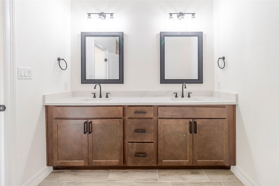 A dual quartz vanity means the morning routine doesn’t require negotiations. A dual quartz vanity means the morning routine doesn’t require negotiations.