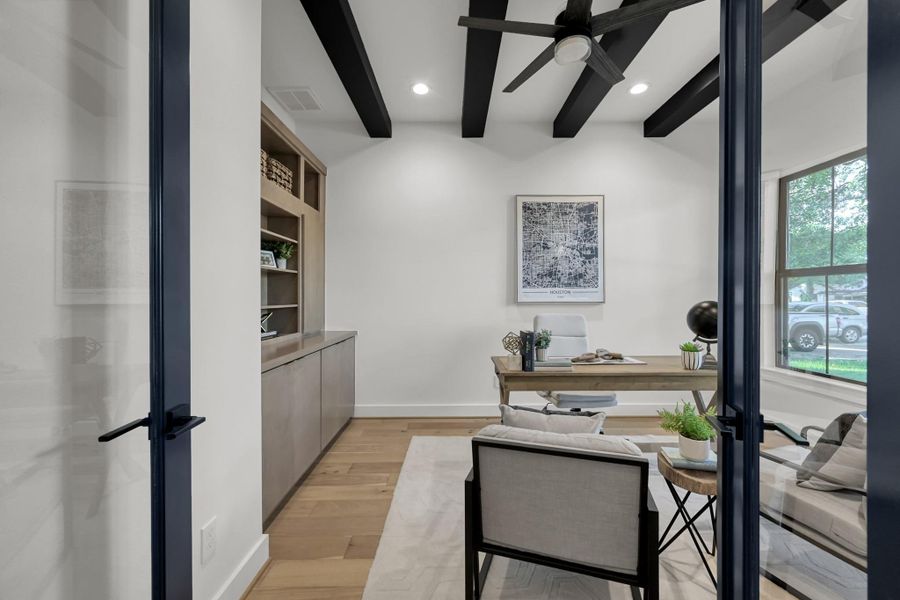 View from the entry highlighting the open-concept layout and modern black-framed doors. View from the entry highlighting the open-concept layout and modern black-framed doors.