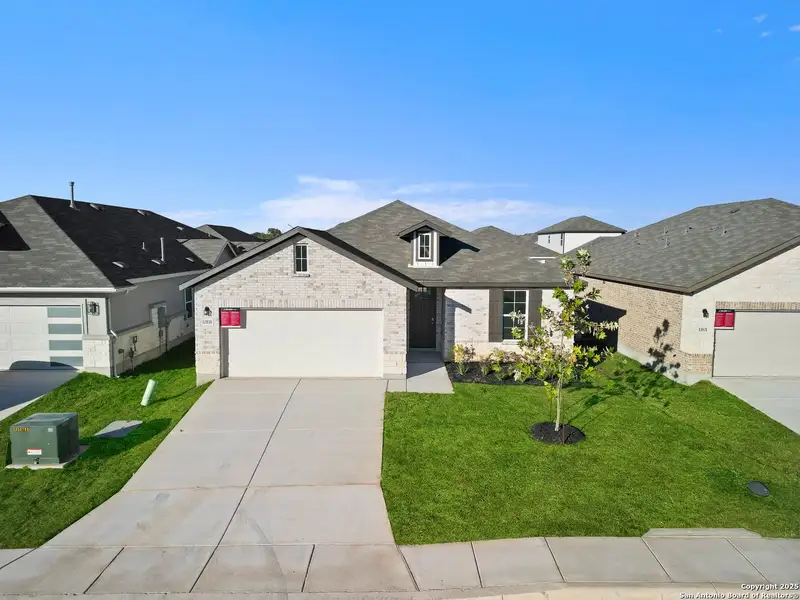 Front exterior of a new home in Veranda: Premier, San Antonio, TX, highlighting curb appeal (Image 2).