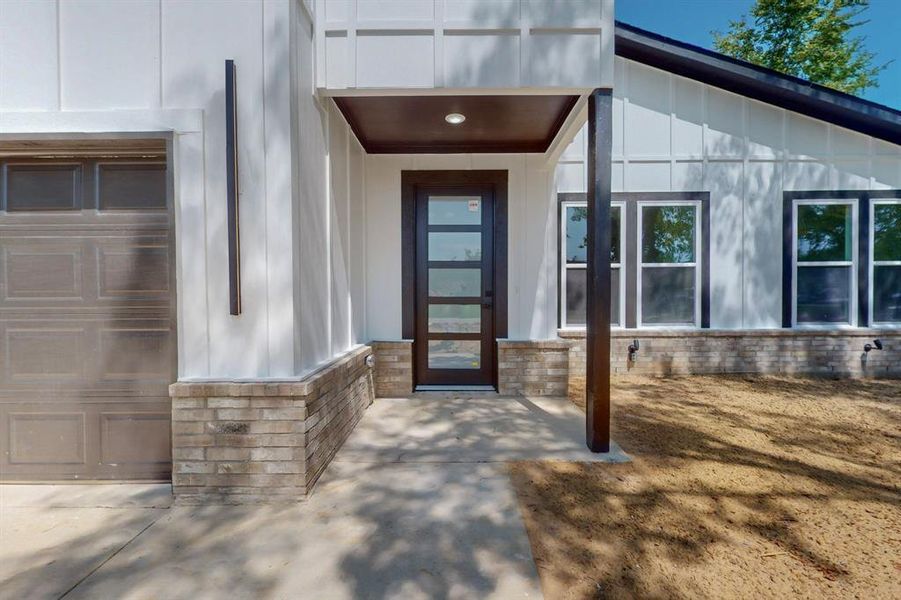 Doorway to property with a garage