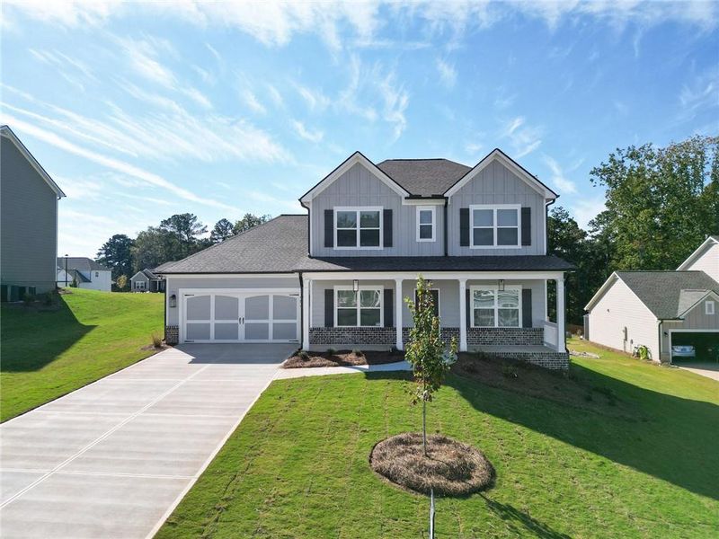 Front exterior of a new home in Calgary Downs, Winder, GA, highlighting curb appeal (Image 1).