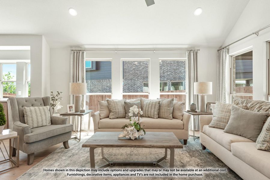 Living room with beige sofa, accent chair, wood coffee table, and large windows with natural light Living room with beige sofa, accent chair, wood coffee table, and large windows with natural light
