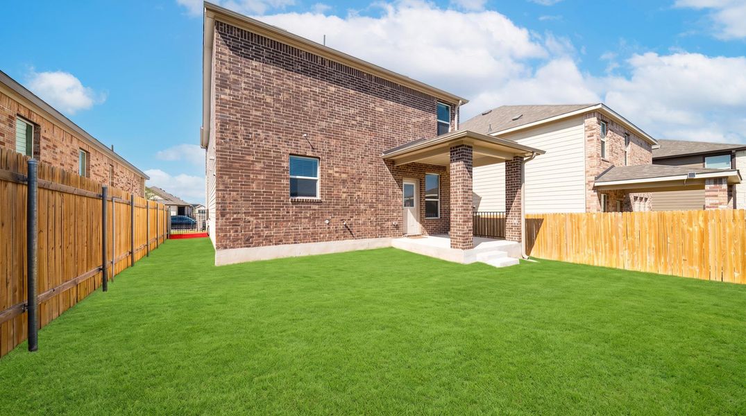A spacious backyard with a covered patio, perfect for outdoor living and entertaining. A spacious backyard with a covered patio, perfect for outdoor living and entertaining.