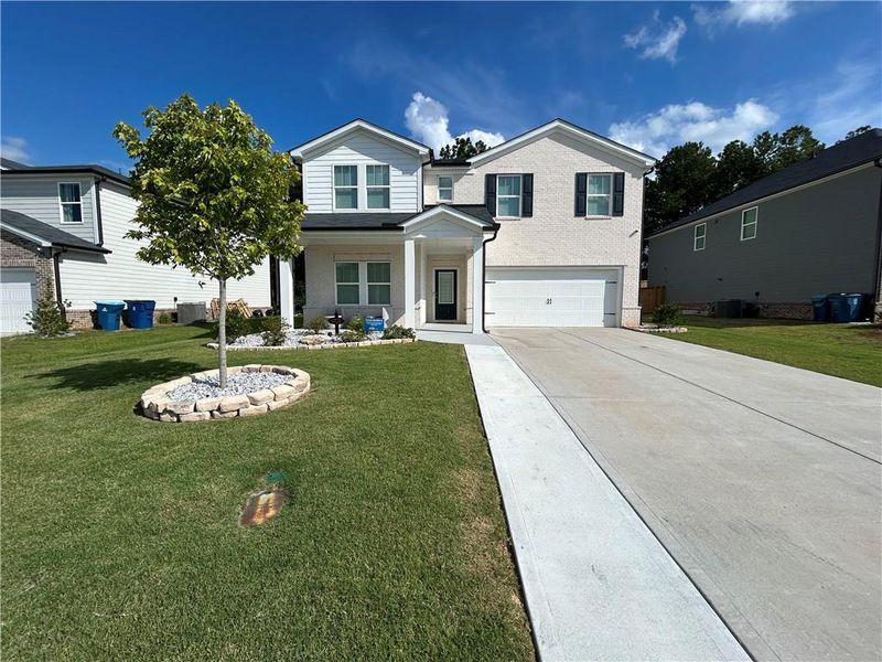 Front exterior of a new home in , Loganville, GA, highlighting curb appeal (Image 21).