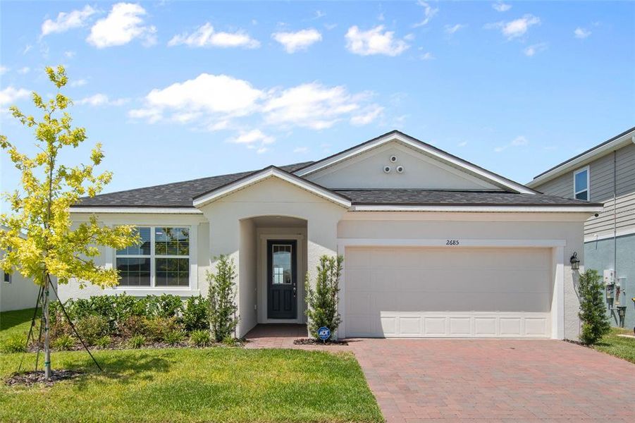 Front exterior of a new home in Waterbrooke, Clermont, FL, highlighting curb appeal (Image 24).