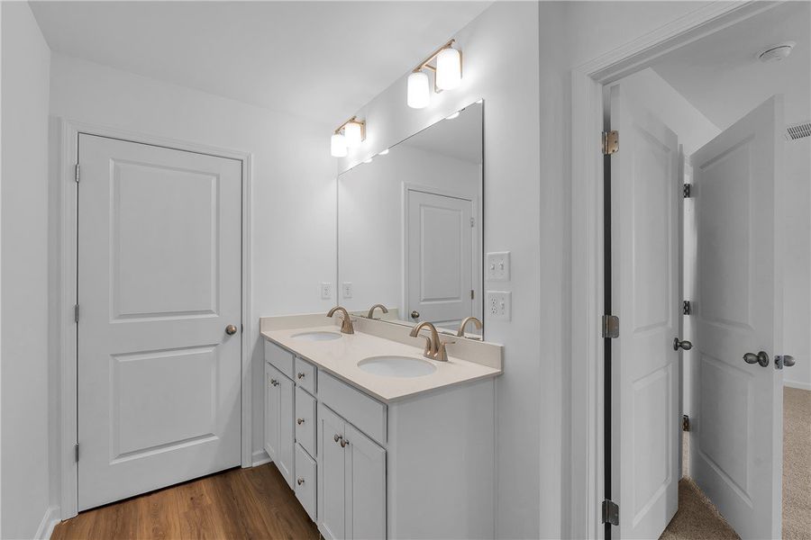 This modern bathroom features a double vanity and This modern bathroom features a double vanity and