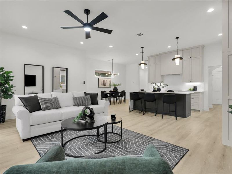 Living room with ceiling fan and light hardwood / wood-style flooring