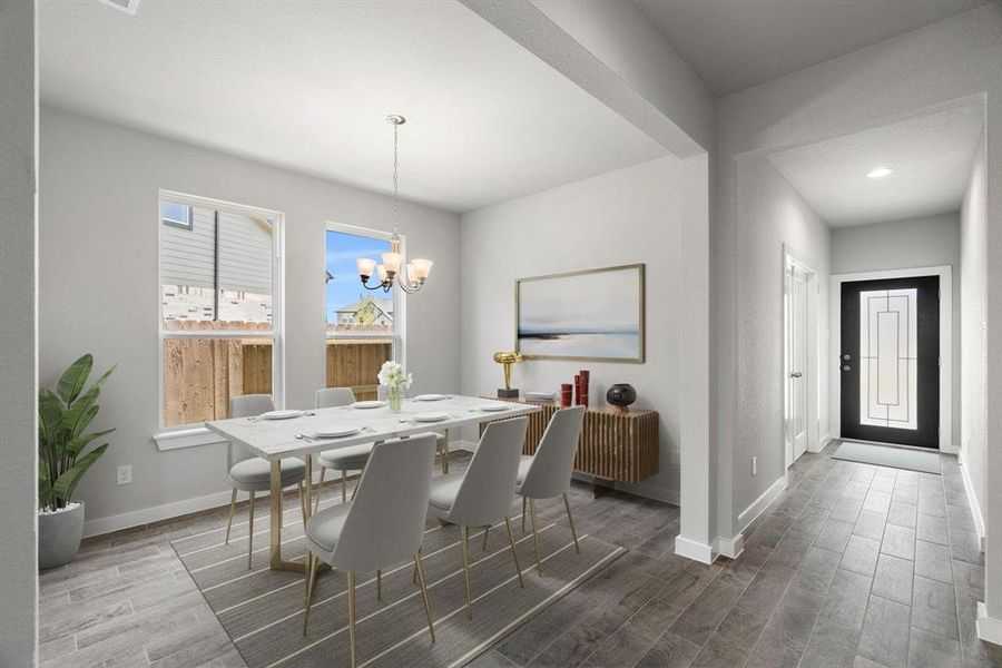 An inviting dining space adjacent to the kitchen for convenience. Revel in the stunning floors and soothing paint palette – a perfect setting for shared meals and cherished moments. Virtually staged.