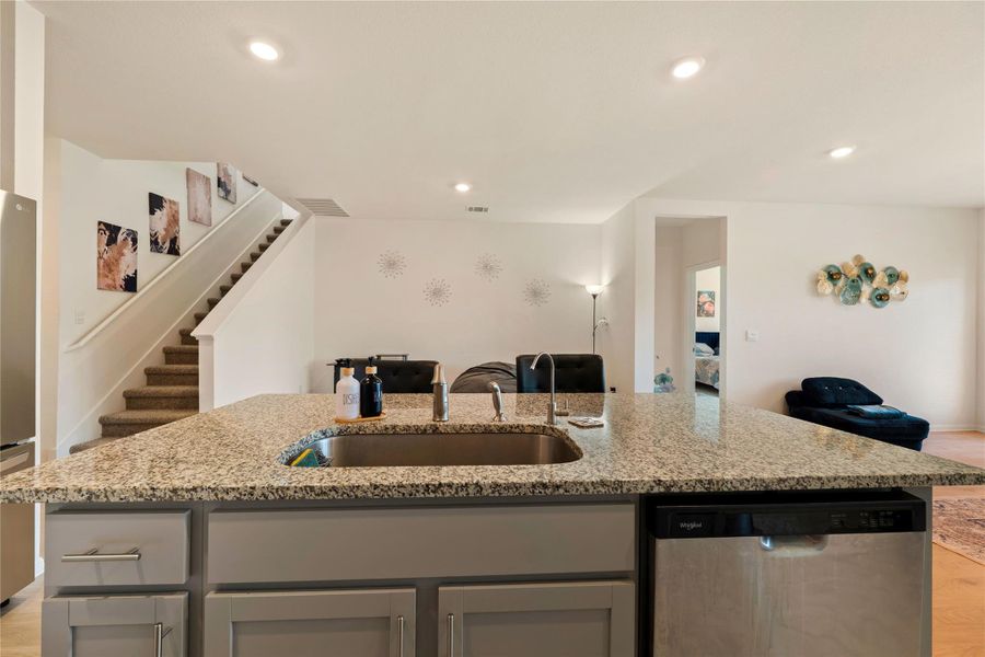 Kitchen island provides a perfect focal point for gatherings and meal preparation.