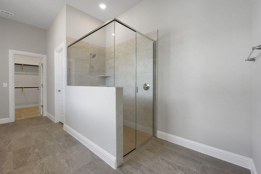 Full bathroom featuring a walk in closet and walk in shower