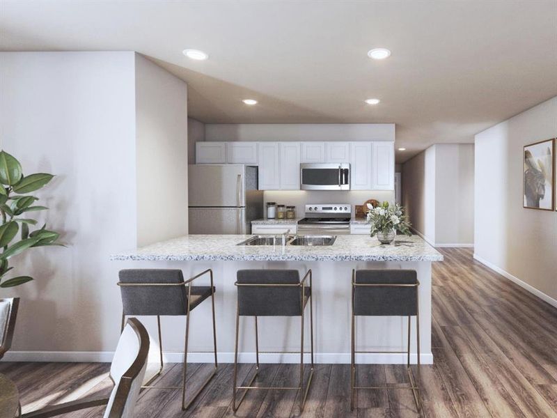 Kitchen with stainless steel microwave, a sink, freestanding refrigerator, dark wood-style flooring, and electric stove