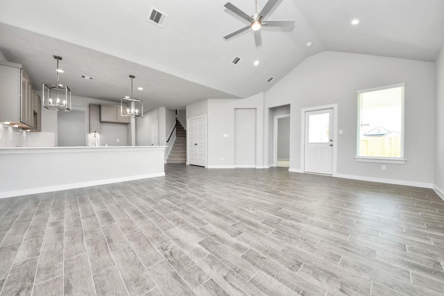 Relax and unwind in this inviting family room, illuminated by abundant natural light streaming in through tall windows, complemented by high ceilings and stunning flooring. Stay comfortable year-round with the gentle breeze from the ceiling fan, creating the perfect atmosphere for family gatherings. Sample photo of completed home with similar floor plan. Actual colors and selections may vary. Relax and unwind in this inviting family room, illuminated by abundant natural light streaming in through tall windows, complemented by high ceilings and stunning flooring. Stay comfortable year-round with the gentle breeze from the ceiling fan, creating the perfect atmosphere for family gatherings. Sample photo of completed home with similar floor plan. Actual colors and selections may vary.