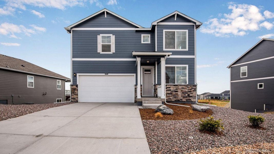 Front exterior of a new home in Settlers Crossing, Commerce City, CO, highlighting curb appeal (Image 1). Front exterior of a new home in Settlers Crossing, Commerce City, CO, highlighting curb appeal (Image 1).