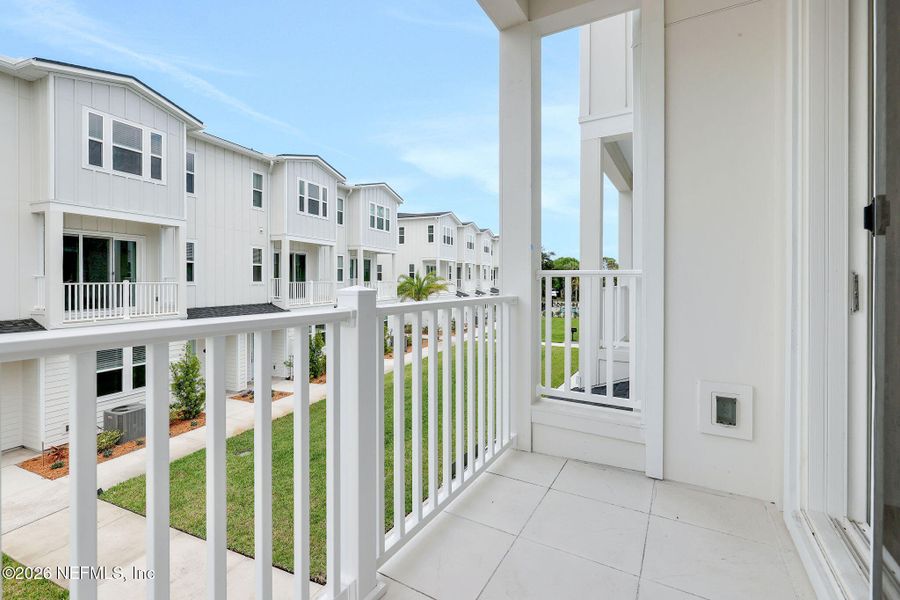 Exterior details and patio area of a home in North Beach Townhomes, Jacksonville Beach (Image 3).