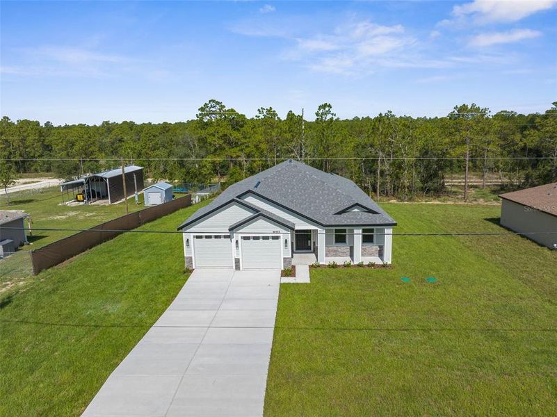 Front exterior of a new home in , Weeki Wachee, FL, highlighting curb appeal (Image 1).