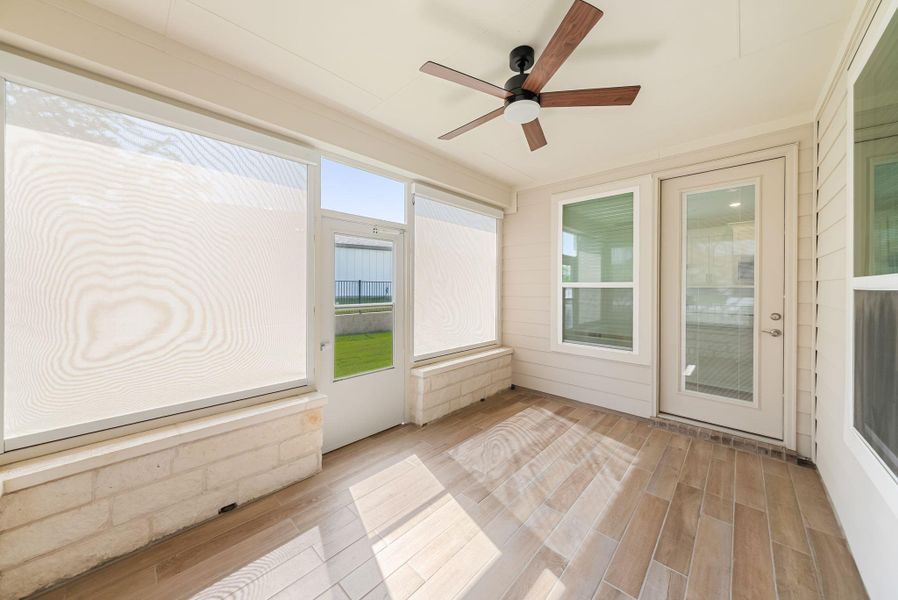 A well-lit screened patio with wood-look tile flooring offers an inviting outdoor retreat. A well-lit screened patio with wood-look tile flooring offers an inviting outdoor retreat.