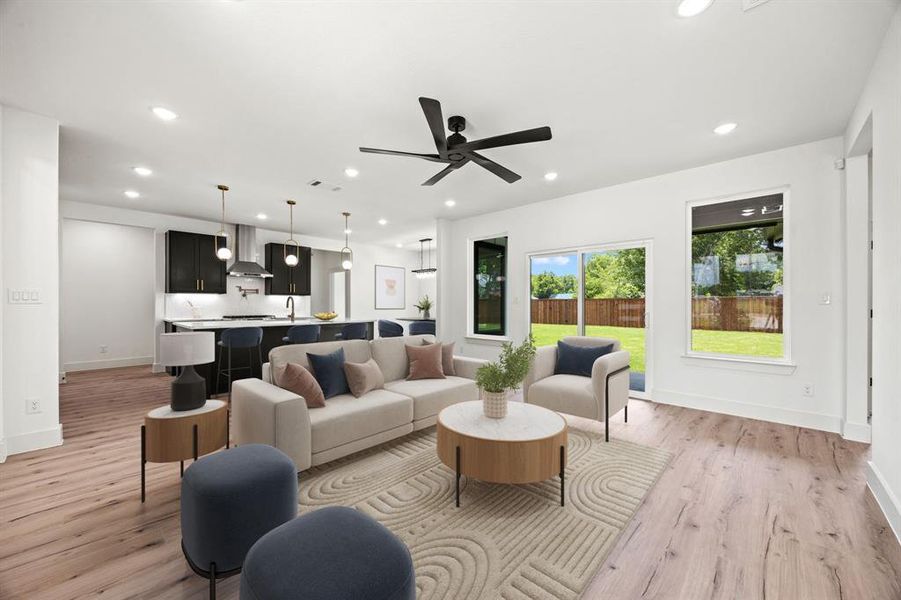 Living area featuring light wood-style flooring, recessed lighting, a ceiling fan, and baseboards Living area featuring light wood-style flooring, recessed lighting, a ceiling fan, and baseboards