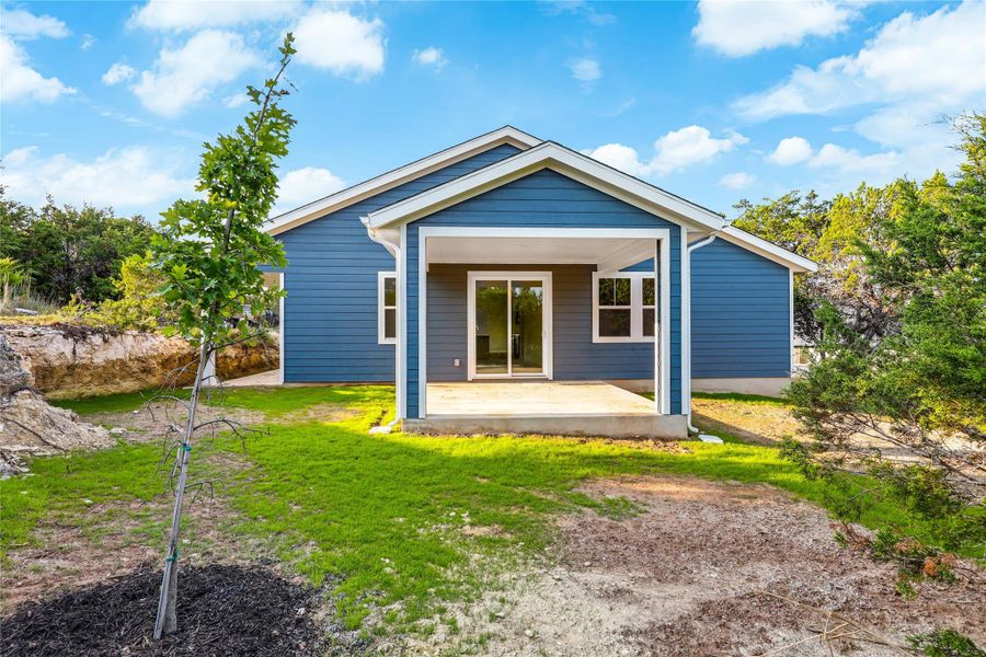 Back of house with a yard and a patio Back of house with a yard and a patio