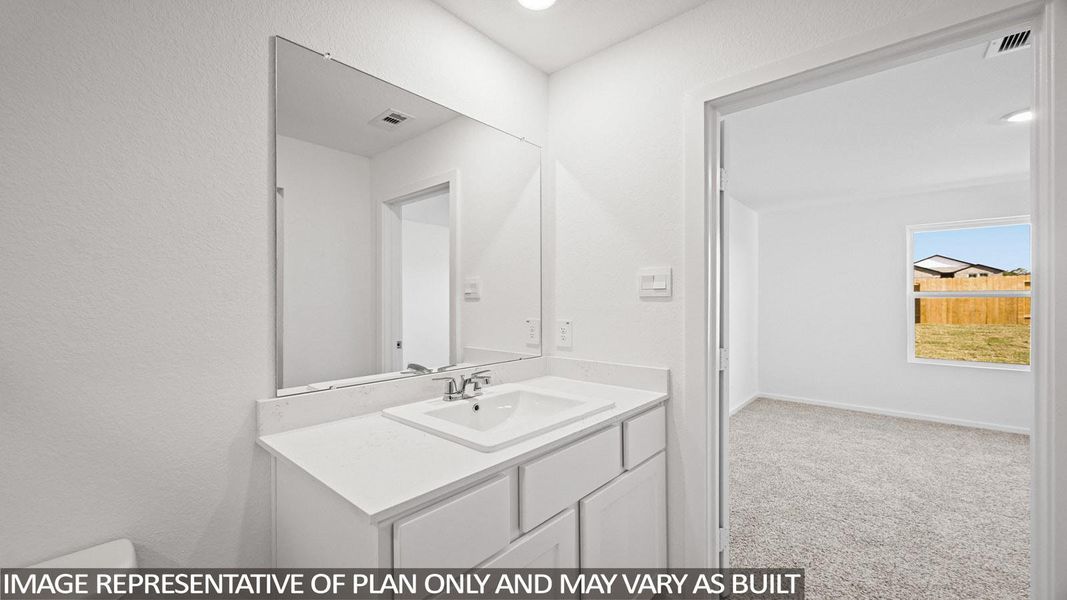 Bathroom featuring vanity, light colored carpet, and recessed lighting