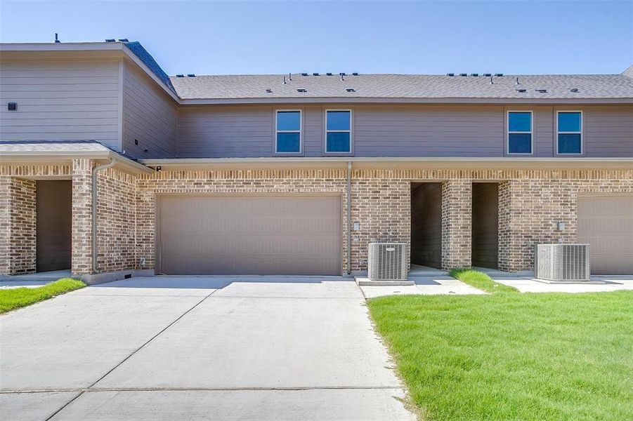 View of front of house with driveway, a garage, and brick siding View of front of house with driveway, a garage, and brick siding