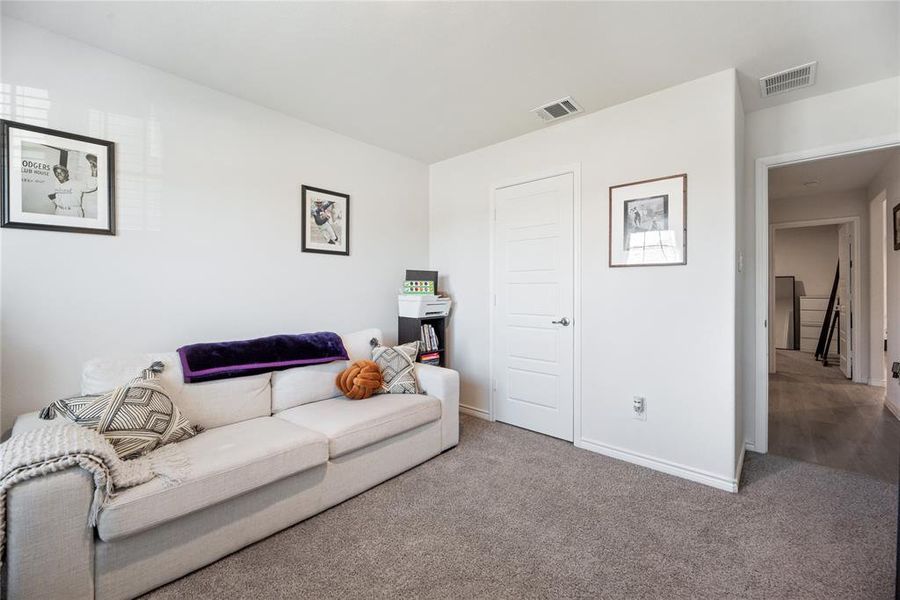 Carpeted living area with baseboards