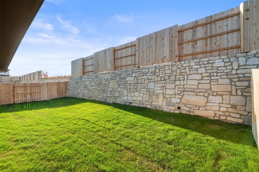 Exterior details and patio area of a home in Lariat, Liberty Hill (Image 26).