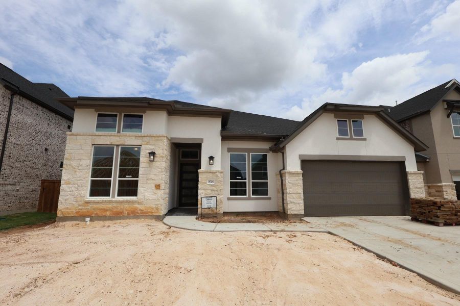 Front exterior of a new home in Dunham Pointe, Cypress, TX, highlighting curb appeal (Image 1). Front exterior of a new home in Dunham Pointe, Cypress, TX, highlighting curb appeal (Image 1).