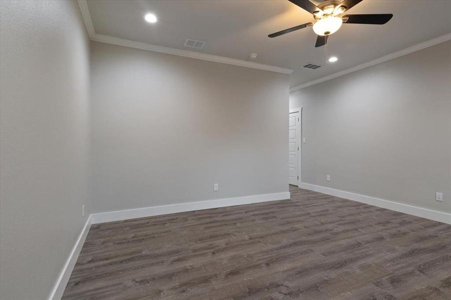 Spare room featuring ornamental molding, ceiling fan, and hardwood / wood-style floors