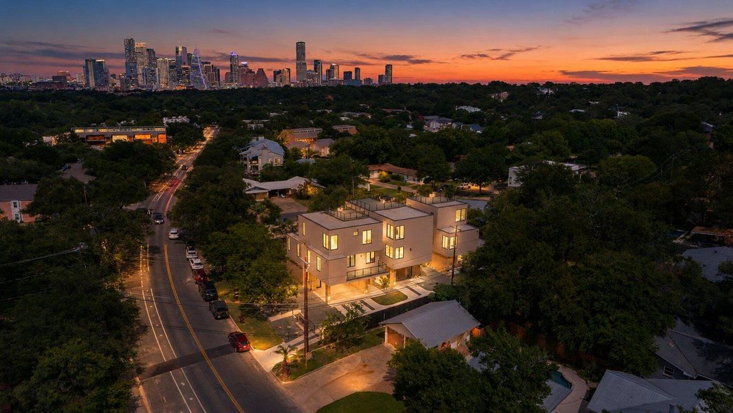 Modern architecture gleams under a vibrant sunset with city lights in the distance. Modern architecture gleams under a vibrant sunset with city lights in the distance.