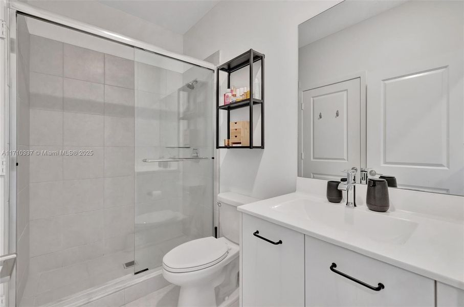 Bathroom accessible from a bedroom, or from the hallway, upstairs, with a walk in shower