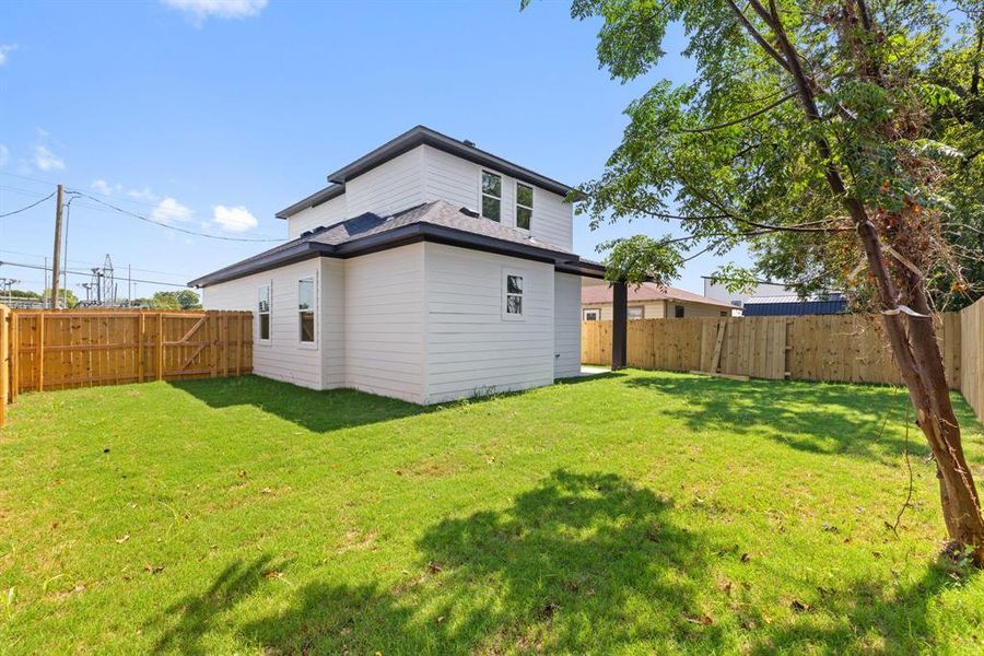 Rear view of property featuring a fenced backyard