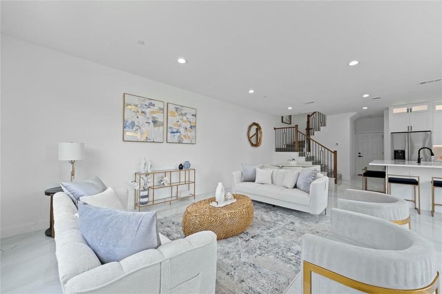 Living room with stairway, recessed lighting, and baseboards