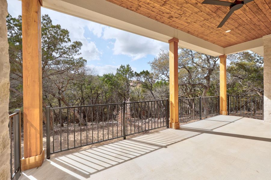 Private patio with wood ceiling accent overlooking greenbelt