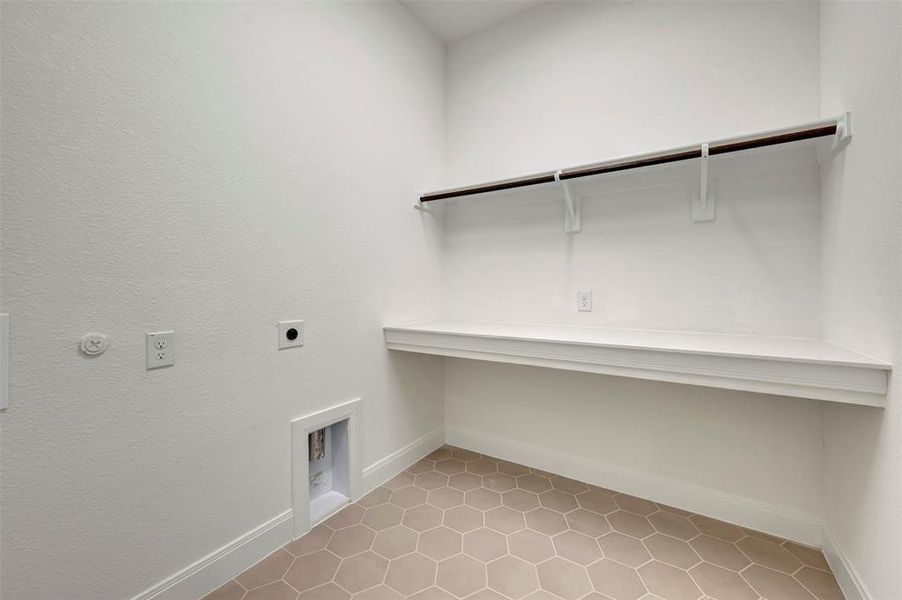 Laundry room with light tile patterned floors, hookup for an electric dryer, and gas dryer hookup
