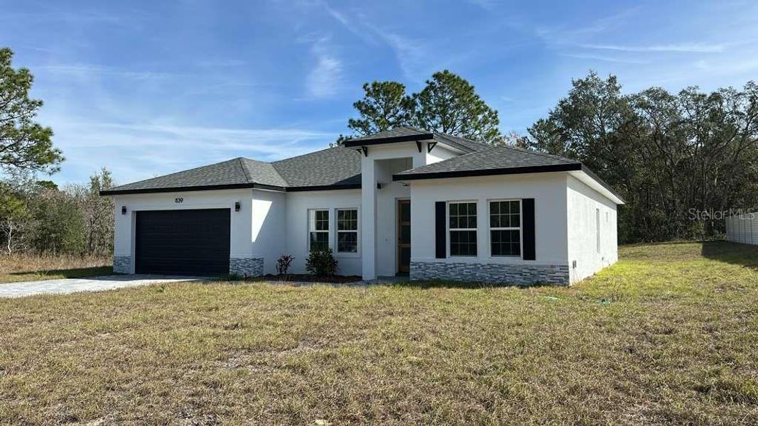 Front exterior of a new home in , Ocala, FL, highlighting curb appeal (Image 14).
