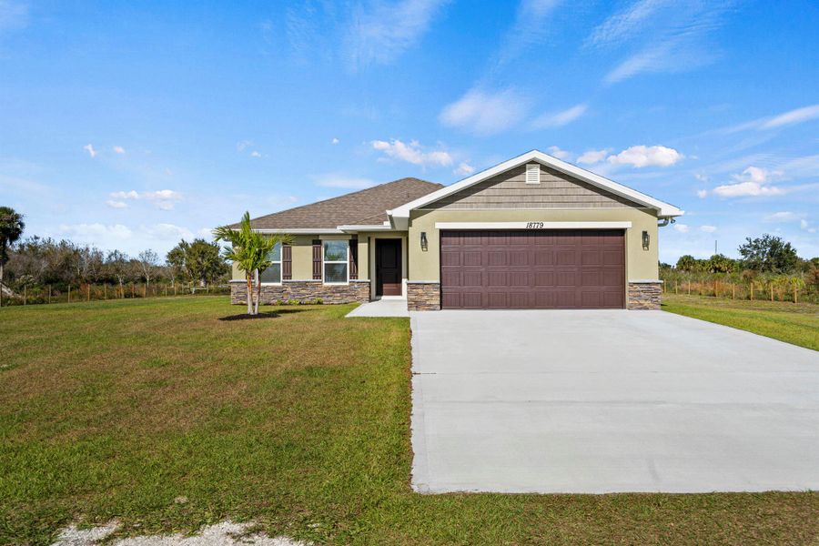 Front exterior of a new home in , Okeechobee, FL, highlighting curb appeal (Image 25).