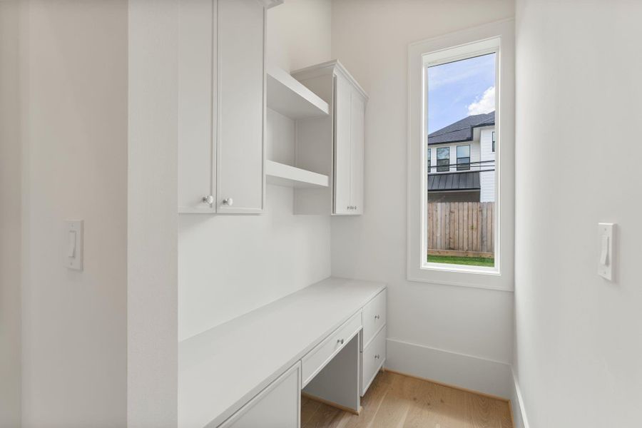 Additional built-in storage and workspace create a functional drop zone, ideal for organization while maintaining the home’s clean and polished look.