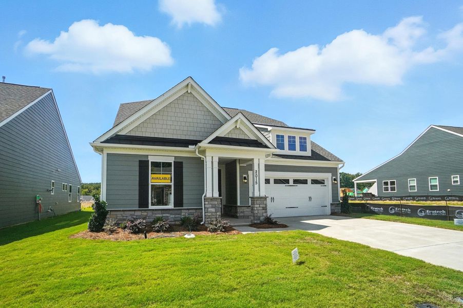 Front exterior of a new home in Heritage - 55+ Community, Indian Trail, NC, highlighting curb appeal (Image 22). Front exterior of a new home in Heritage - 55+ Community, Indian Trail, NC, highlighting curb appeal (Image 22).